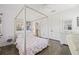 Well-lit bedroom with wood floors, a four-poster bed with floral bedding, and classic decor at 311 12Th N Ave, St Petersburg, FL 33701