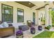 Inviting front porch with cushioned wicker furniture and potted plants, perfect for relaxing outdoors at 311 12Th N Ave, St Petersburg, FL 33701