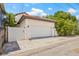 Detached garage with a white door and brick-paved driveway at 311 12Th N Ave, St Petersburg, FL 33701