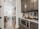 Gourmet kitchen with stainless steel microwave and built-in wet bar with wine storage and stone countertops at 311 12Th N Ave, St Petersburg, FL 33701