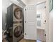 Bright laundry area with a gray stacked washer and dryer setup conveniently located adjacent to the bathroom at 311 12Th N Ave, St Petersburg, FL 33701