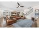 Open floorplan connects a spacious living room with a large sectional, dining area, and modern kitchen at 311 12Th N Ave, St Petersburg, FL 33701