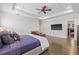 Large main bedroom showcases a trey ceiling, hardwood floors, a TV, and a seating area with a leather ottoman at 311 12Th N Ave, St Petersburg, FL 33701