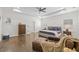 Spacious main bedroom featuring a tray ceiling, hardwood floors, and a cozy seating area with a leather chair at 311 12Th N Ave, St Petersburg, FL 33701
