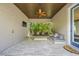 Inviting covered outdoor patio with comfortable seating, ceiling fan, and travertine flooring at 311 12Th N Ave, St Petersburg, FL 33701