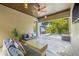 Outdoor patio with comfortable seating overlooking a pool and lush tropical foliage at 311 12Th N Ave, St Petersburg, FL 33701