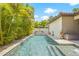 Beautiful pool surrounded by lush tropical foliage and a white fence, perfect for relaxation at 311 12Th N Ave, St Petersburg, FL 33701