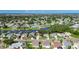 Wide aerial shot of a charming neighborhood with waterfront access, lush trees, and well-maintained yards at 318 Lookout Dr, Apollo Beach, FL 33572