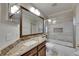 Bathroom features a granite-topped vanity and a glass-enclosed shower over tub at 318 Lookout Dr, Apollo Beach, FL 33572