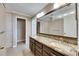 Bathroom with dual sink vanity, large mirror, tiled walls, and tile flooring at 318 Lookout Dr, Apollo Beach, FL 33572