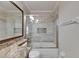 Bathroom showcasing tiled shower over tub with glass door and granite vanity at 318 Lookout Dr, Apollo Beach, FL 33572