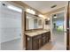 Spacious bathroom with double sink vanity, granite countertops and walk in closet at 318 Lookout Dr, Apollo Beach, FL 33572