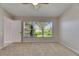 Bedroom with ceiling fan and window showing the well maintained backyard at 318 Lookout Dr, Apollo Beach, FL 33572