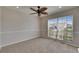 This bedroom has a leafy ceiling fan and a large window at 318 Lookout Dr, Apollo Beach, FL 33572