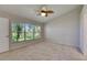 Bedroom with ceiling fan and window showing the yard at 318 Lookout Dr, Apollo Beach, FL 33572