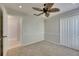 This bedroom features a ceiling fan, closet, and door that leads to the bathroom at 318 Lookout Dr, Apollo Beach, FL 33572