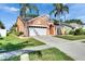 Charming single-story home with a well-maintained lawn, mature landscaping and two-car garage at 318 Lookout Dr, Apollo Beach, FL 33572