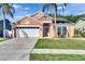 Charming single-story home with a well-maintained lawn, mature landscaping and two-car garage at 318 Lookout Dr, Apollo Beach, FL 33572
