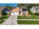 Charming single-Gathering home featuring a well-maintained lawn, mature palms, and a two-car garage at 318 Lookout Dr, Apollo Beach, FL 33572