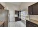 Bright kitchen features granite countertops, stainless steel refrigerator, and lots of cabinet space at 318 Lookout Dr, Apollo Beach, FL 33572