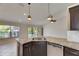Kitchen island features stainless steel dishwasher, granite countertops and undermount sink at 318 Lookout Dr, Apollo Beach, FL 33572