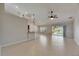 Spacious living room with tile floors, ceiling fan and sliding glass doors to the lanai at 318 Lookout Dr, Apollo Beach, FL 33572