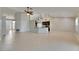 Open-concept living room and kitchen with tile floors and high ceilings, great for entertaining at 318 Lookout Dr, Apollo Beach, FL 33572