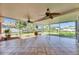Enclosed tiled patio offering picturesque backyard views and lush landscaping at 318 Lookout Dr, Apollo Beach, FL 33572