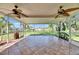 Enclosed tiled patio offering views of a well-maintained lawn and tropical landscaping at 318 Lookout Dr, Apollo Beach, FL 33572