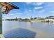 Scenic waterfront view with private docks and lush landscaping under a partly cloudy bright blue sky at 318 Lookout Dr, Apollo Beach, FL 33572