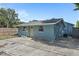 Rear exterior view of a renovated home showing a door and fenced yard at 3201 36Th N Ave, St Petersburg, FL 33713