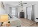 Bedroom featuring a ceiling fan, a window with curtains, a drawer, and a mirror at 3201 36Th N Ave, St Petersburg, FL 33713