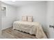 Cozy bedroom with wood laminate flooring and a comfortable bed with decorative pillows at 3201 36Th N Ave, St Petersburg, FL 33713