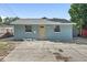 Charming home with a blue exterior, complemented by a concrete driveway and manicured lawn at 3201 36Th N Ave, St Petersburg, FL 33713