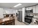 Bright kitchen features stainless steel appliances, light wood floors, and white cabinetry at 3201 36Th N Ave, St Petersburg, FL 33713