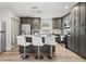 Modern kitchen with stainless steel appliances, kitchen island, and bar stool seating at 3201 36Th N Ave, St Petersburg, FL 33713