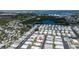 Aerial view of a 55+ community by the water with manufactured homes and lots of green spaces at 3301 Alt 19 # 317, Palm Harbor, FL 34683