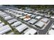 Aerial view showing rows of homes in a community with a street running through it at 3301 Alt 19 # 317, Palm Harbor, FL 34683