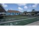 Community shuffleboard courts with outdoor seating and a clubhouse in a well-maintained neighborhood at 3301 Alt 19 # 317, Palm Harbor, FL 34683