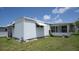 Rear exterior view of a well-maintained home, featuring ample windows and a grassy lawn at 3301 Alt 19 # 317, Palm Harbor, FL 34683