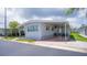 Well-maintained single-story home featuring a covered carport and neat landscaping in a quiet community at 3301 Alt 19 # 317, Palm Harbor, FL 34683
