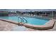 Community pool featuring a fenced perimeter and poolside seating at 3301 Alt 19 # 317, Palm Harbor, FL 34683
