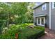 This backyard features a charming wooden deck, beautiful lawn, mature trees, and attractive landscaping at 344 Cascade Ln, Palm Harbor, FL 34684