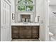 Bathroom with stylish vanity featuring dual sinks, granite counters, and lots of storage space at 344 Cascade Ln, Palm Harbor, FL 34684