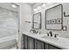 Elegant bathroom featuring double sinks, sleek fixtures, tiled walls, mirrors, and ample lighting for a luxurious feel at 344 Cascade Ln, Palm Harbor, FL 34684