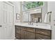 Bright bathroom features a modern vanity, a large framed mirror, and neutral wall paint at 344 Cascade Ln, Palm Harbor, FL 34684