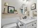 Bright bathroom features a sleek vanity, modern fixtures, an oval mirror, and decorative wall art at 344 Cascade Ln, Palm Harbor, FL 34684