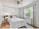 Bright bedroom features a ceiling fan, a window with curtains, and a bed with white linens at 344 Cascade Ln, Palm Harbor, FL 34684