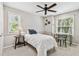 Comfortable bedroom with a ceiling fan, two windows and desk at 344 Cascade Ln, Palm Harbor, FL 34684