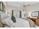 Spacious bedroom featuring king bed, ceiling fan, and patio doors that lead to outdoor space at 344 Cascade Ln, Palm Harbor, FL 34684